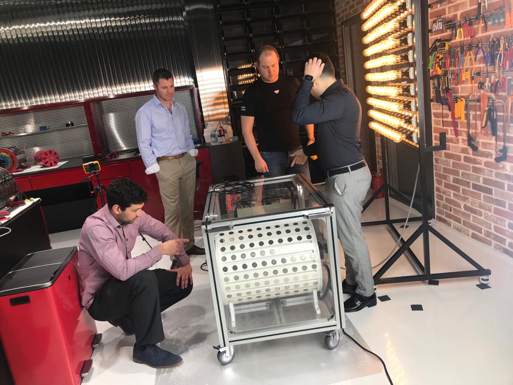 Raven and the team examining the motor-generator from different angles