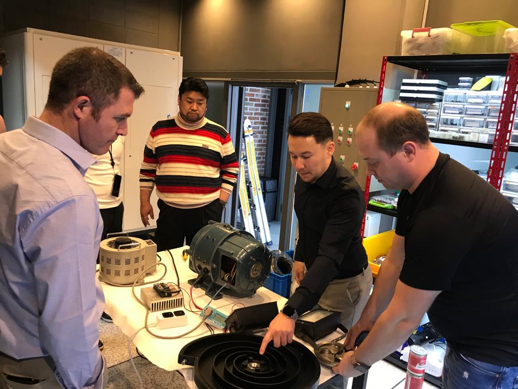 Close examination of motor internals — the team inspects rotor and stator assembly